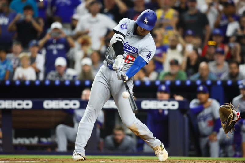 Sep 19, 2024; Miami, Florida, USA; Los Angeles Dodgers designated hitter Shohei Ohtani (17) hits a two-run home run against the Miami Marlins during the seventh inning at loanDepot Park. Mandatory Credit: Sam Navarro-Imagn Images