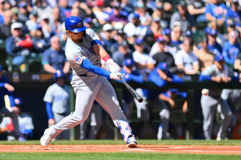 Apr 14, 2024; Seattle, Washington, USA; Chicago Cubs designated hitter Seiya Suzuki (27) hits a double against the Seattle Mariners during the first inning at T-Mobile Park. Mandatory Credit: Steven Bisig-USA TODAY Sports