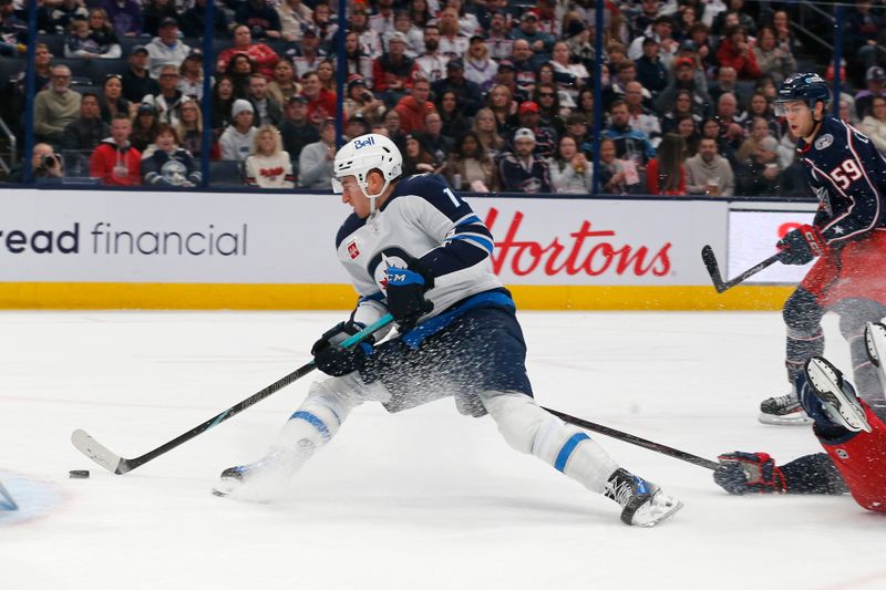 Nov 1, 2024; Columbus, Ohio, USA; Winnipeg Jets center Gabriel Vilardi (13) shoots as he falls to the ice against the Columbus Blue Jackets during the first period at Nationwide Arena. Mandatory Credit: Russell LaBounty-Imagn Images