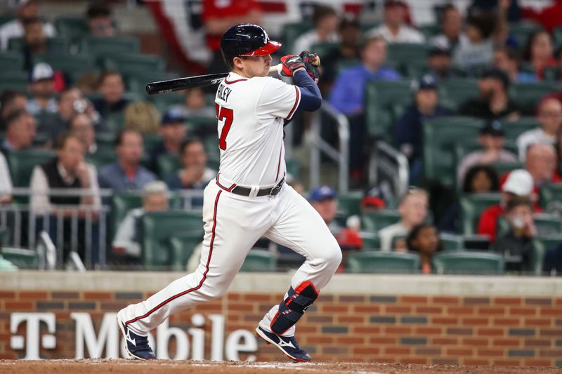 Apr 11, 2023; Atlanta, Georgia, USA; Atlanta Braves third baseman Austin Riley (27) hits a single against the Cincinnati Reds in the fifth inning at Truist Park. Mandatory Credit: Brett Davis-USA TODAY Sports
