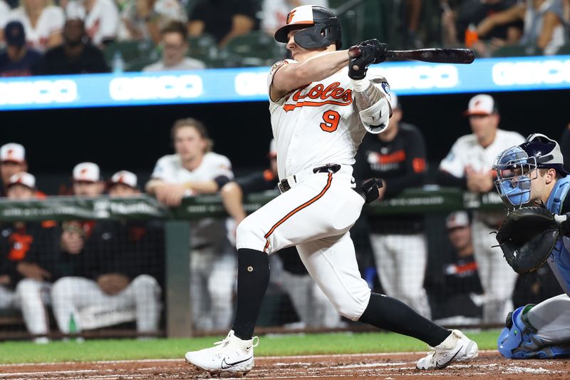 Sep 23, 2025; Baltimore, Maryland, USA; Baltimore Orioles outfielder Tyler O'Neill (9) drives in a run during the first inning against the Tampa Bay Rays at Oriole Park at Camden Yards. Mandatory Credit: Daniel Kucin Jr.-Imagn Images