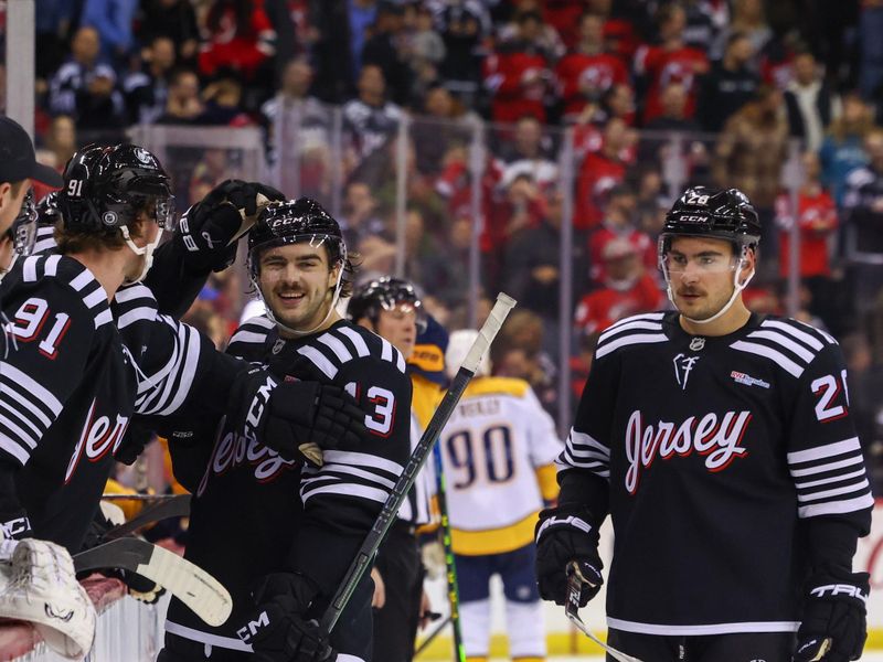 Nov 25, 2024; Newark, New Jersey, USA; New Jersey Devils center Nico Hischier (13) celebrates his goal against the Nashville Predators during the second period at Prudential Center. Mandatory Credit: Ed Mulholland-Imagn Images