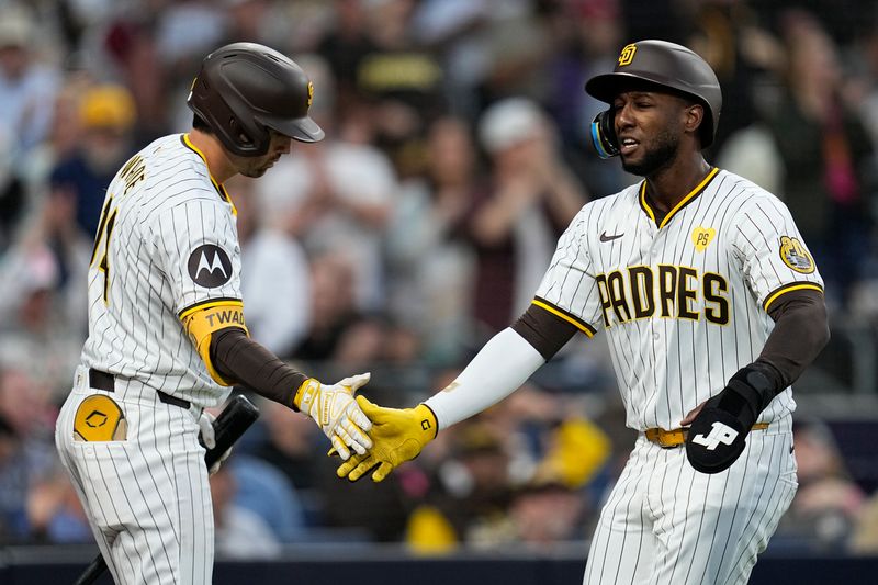 Apr 2, 2024; San Diego, California, USA; San Diego Padres left fielder Jurickson Profar (10) is congratulated by third baseman Tyler Wade (14) after scoring against the St. Louis Cardinals during the second inning at Petco Park. Mandatory Credit: Ray Acevedo-USA TODAY Sports