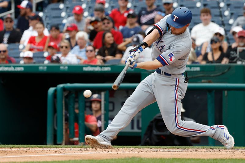 Jul 9, 2023; Washington, District of Columbia, USA; Texas Rangers shortstop Corey Seager (5) singles against the Washington Nationals during the fourth inning at Nationals Park. Mandatory Credit: Geoff Burke-USA TODAY Sports