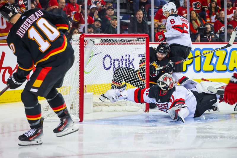 Dec 9, 2023; Calgary, Alberta, CAN; New Jersey Devils goaltender Vitek Vanecek (41) guards his net as Calgary Flames center Jonathan Huberdeau (10) tries to score during the second period at Scotiabank Saddledome. Mandatory Credit: Sergei Belski-USA TODAY Sports
