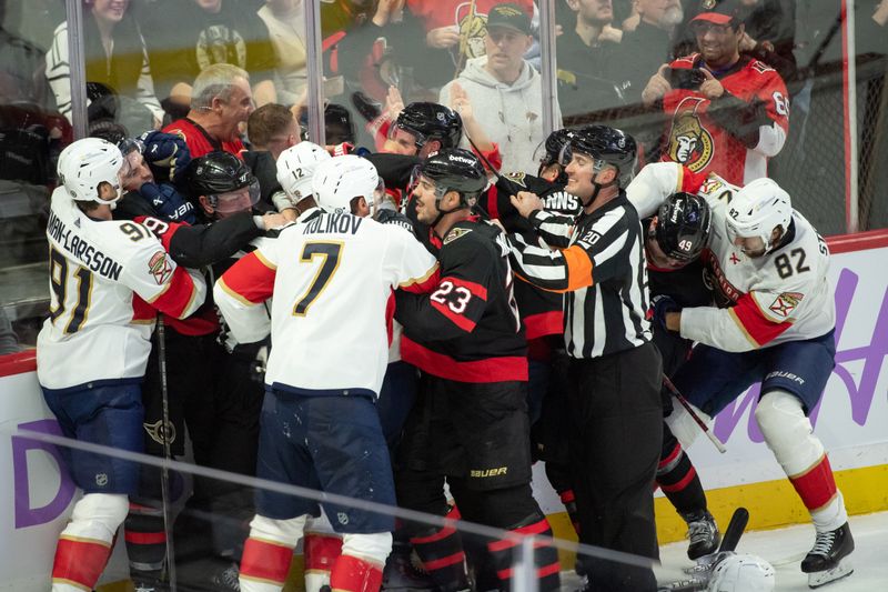 Nov 27 2023; Ottawa, Ontario, CAN; The entire Florida Panthers line including defensemen Oliver Ekman-Larsson (91) and Dmitry Kulikov (7) fight with the Ottawa Senators line which includes defenseman Travis Hamonic (23) and defenseman Erik Brannstrom (26) in the third period at the Canadian Tire Centre. Mandatory Credit: Marc DesRosiers-USA TODAY Sports