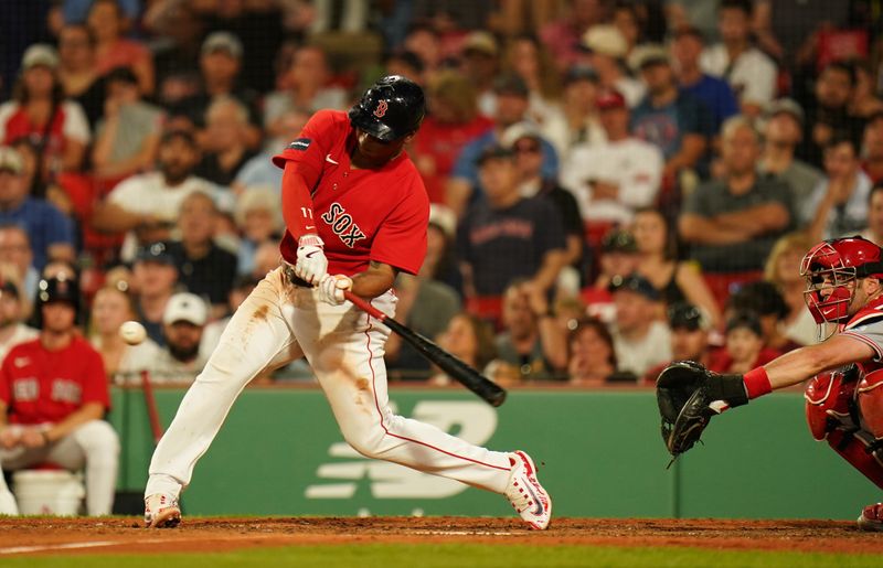 Jun 1, 2023; Boston, Massachusetts, USA; Boston Red Sox third baseman Rafael Devers (11) hits a double to center field to drive in a run against the Cincinnati Reds in the eighth inning at Fenway Park. Mandatory Credit: David Butler II-USA TODAY Sports