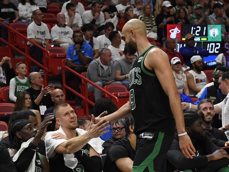 MIAMI, FL - APRIL 27: Derrick White #9 high fives Kristaps Porzingis #8 of the Boston Celtics during the game against the Miami Heat during Round 1 Game 3 of the 2024 NBA Playoffs on April 27, 2024 at Kaseya Center in Miami, Florida. NOTE TO USER: User expressly acknowledges and agrees that, by downloading and or using this Photograph, user is consenting to the terms and conditions of the Getty Images License Agreement. Mandatory Copyright Notice: Copyright 2024 NBAE (Photo by Brian Babineau/NBAE via Getty Images)