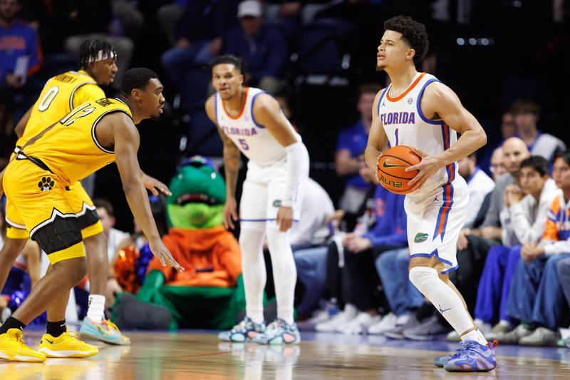 Jan 14, 2025; Gainesville, Florida, USA; Florida Gators guard Walter Clayton Jr. (1) looks to pass against Missouri Tigers guard Tony Perkins (12) during the first half at the Stephen C. O'Connell Center in Gainesville, FL on Tuesday, January 14, 2025. Mandatory Credit: Matt Pendleton-Imagn Images