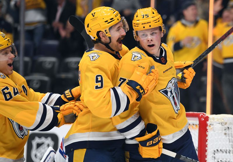 Nov 12, 2022; Nashville, Tennessee, USA; Nashville Predators center Juuso Parssinen (75) celebrates with left wing Filip Forsberg (9) and center Mikael Granlund (64) after scoring his first career goal during the first period against the New York Rangers at Bridgestone Arena. Mandatory Credit: Christopher Hanewinckel-USA TODAY Sports