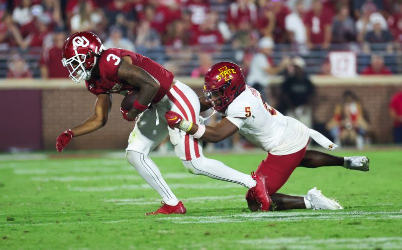 Sep 30, 2023; Norman, Oklahoma, USA;  Iowa State Cyclones defensive back Myles Purchase (5) tackles Oklahoma Sooners wide receiver Jalil Farooq (3) during the second half at Gaylord Family-Oklahoma Memorial Stadium. Mandatory Credit: Kevin Jairaj-USA TODAY Sports