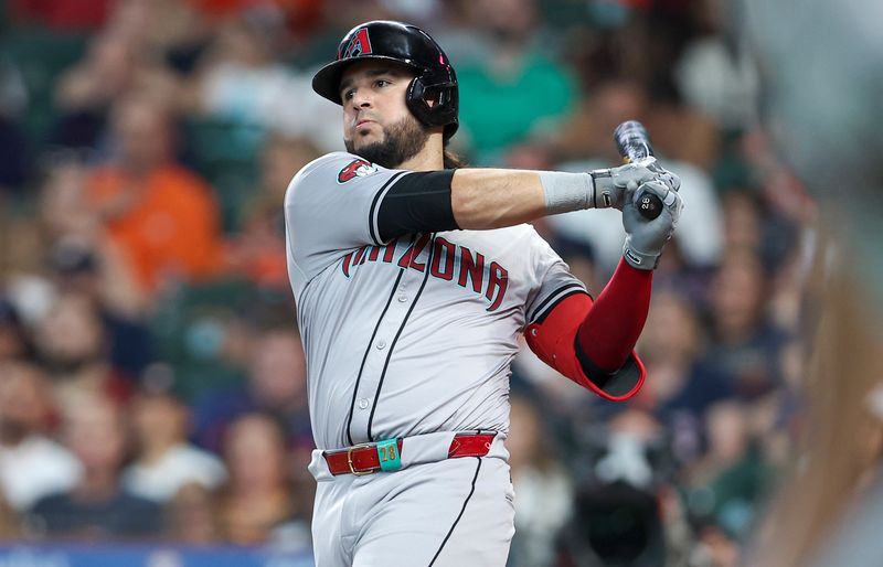 Sep 8, 2024; Houston, Texas, USA; Arizona Diamondbacks third baseman Eugenio Suarez (28) hits an RBI single during the third inning against the Houston Astros at Minute Maid Park. Mandatory Credit: Troy Taormina-Imagn Images