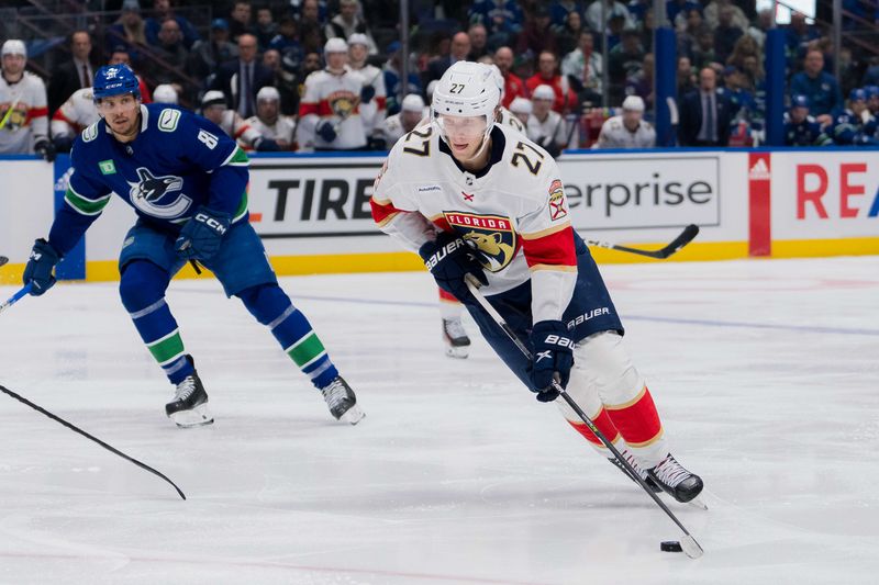 Dec 14, 2023; Vancouver, British Columbia, CAN; Florida Panthers forward Eetu Luostarinen (27) handles the puck against the Vancouver Canucks in the second period at Rogers Arena. Vancouver won 4-0. Mandatory Credit: Bob Frid-USA TODAY Sports