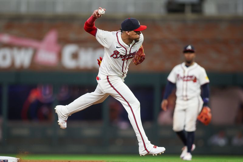 Sep 24, 2024; Atlanta, Georgia, USA; Atlanta Braves shortstop Orlando Arcia (11) throws a runner out at first against the New York Mets in the seventh inning at Truist Park. Mandatory Credit: Brett Davis-Imagn Images
