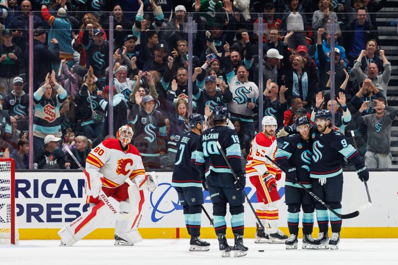 Oct 19, 2024; Seattle, Washington, USA; Seattle Kraken center Chandler Stephenson (9) celebrates with teammates after scoring a goal against the Calgary Flames during the second period at Climate Pledge Arena. Mandatory Credit: Caean Couto-Imagn Images