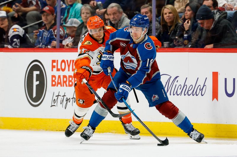 Jan 21, 2026; Denver, Colorado, USA; Colorado Avalanche center Jack Drury (18) controls the puck as Anaheim Ducks center Tim Washe (42) in the third period at Ball Arena. Mandatory Credit: Isaiah J. Downing-Imagn Images