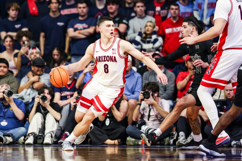 Jan 21, 2026; Tucson, Arizona, USA; Arizona Wildcats forward Ivan Kharchenkov (8) dribbles the ball during the first half of the game at McKale Memorial Center. Mandatory Credit: Aryanna Frank-Imagn Images
