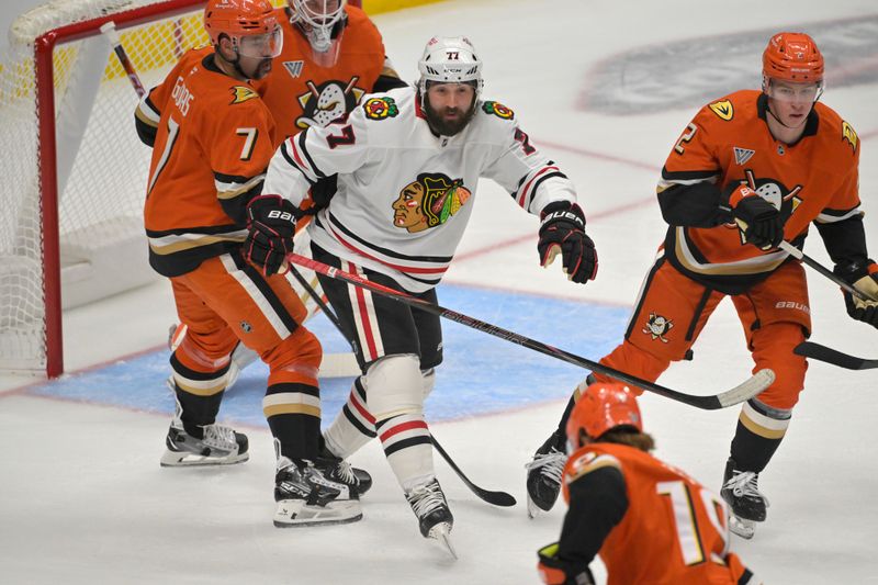 Nov 3, 2024; Anaheim, California, USA;  Chicago Blackhawks left wing Patrick Maroon (77), Anaheim Ducks defenseman Radko Gudas (7) and Anaheim Ducks defenseman Jackson LaCombe (2) battle for position in front of the net in the first period at Honda Center. Mandatory Credit: Jayne Kamin-Oncea-Imagn Images