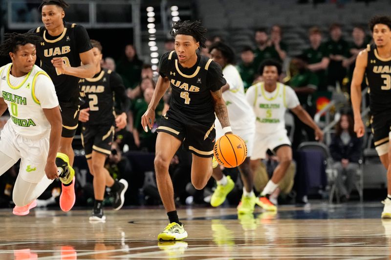 Mar 16, 2024; Fort Worth, TX, USA;  UAB Blazers guard Eric Gaines (4) dribbles the ball up court against South Florida Bulls guard Jayden Reid (0) during the first half at Dickies Arena. Mandatory Credit: Chris Jones-USA TODAY Sports