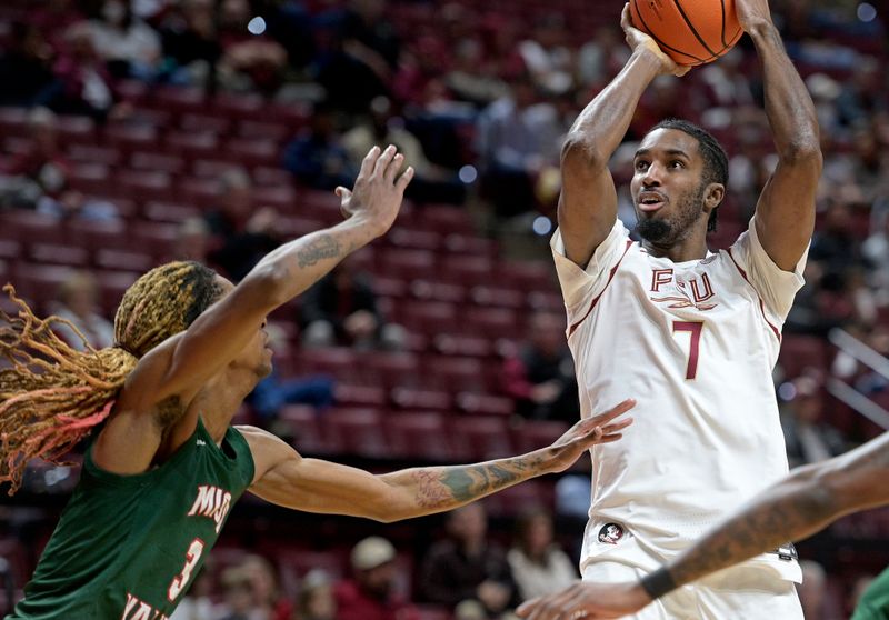 Dec 19, 2025; Tallahassee, Florida, USA; Florida State Seminoles forward Chauncey Wiggins (7) shoots the ball as Mississippi Valley State Delta Devils forward Lamont Sams (3) defends during the first half at Donald L. Tucker Center. Mandatory Credit: Melina Myers-Imagn Images