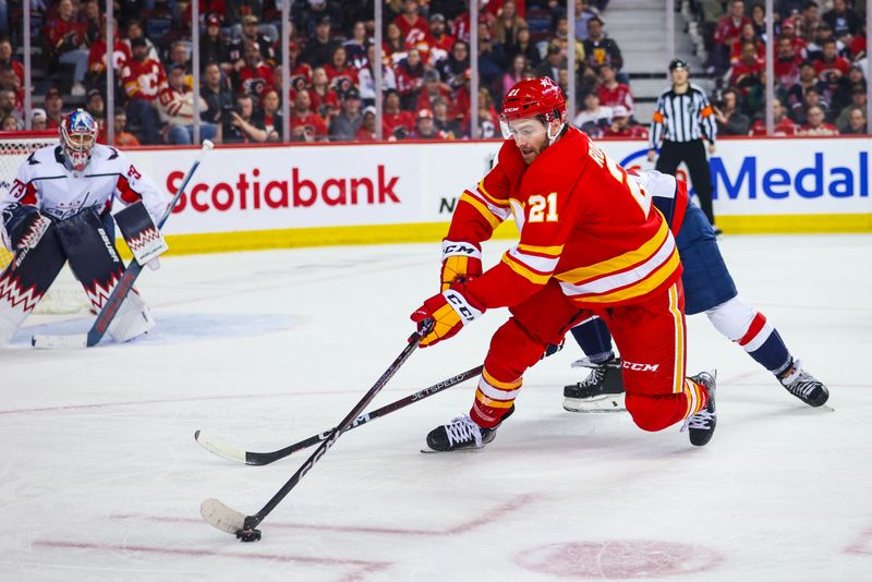 Mar 18, 2024; Calgary, Alberta, CAN; Calgary Flames center Kevin Rooney (21) controls the puck against the Washington Capitals during the second period at Scotiabank Saddledome. Mandatory Credit: Sergei Belski-USA TODAY Sports