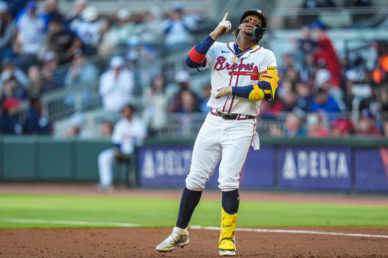 Apr 21, 2024; Cumberland, Georgia, USA; Atlanta Braves right fielder Ronald Acuna Jr (13) reacts after hitting a single against the Texas Rangers during the first inning at Truist Park. Mandatory Credit: Dale Zanine-USA TODAY Sports