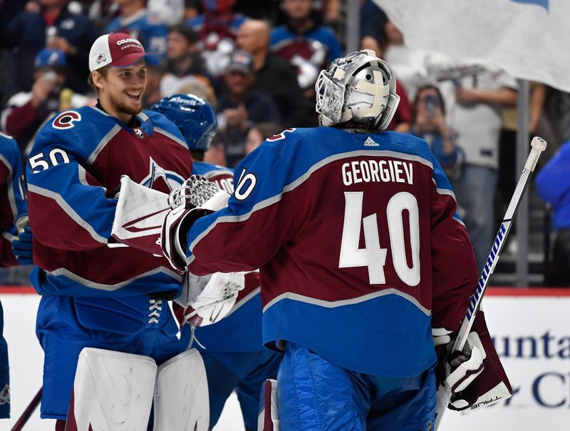 Oct 21, 2023; Denver, Colorado, USA; Colorado Avalanche goaltender Ivan Prosvetov (50) smiles as he congratulates Colorado Avalanche goaltender Alexandar Georgiev (40) after their win over the Carolina Hurricanes at Ball Arena. Mandatory Credit: John Leyba-USA TODAY Sports