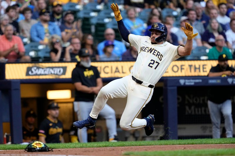 Jul 10, 2024; Milwaukee, Wisconsin, USA;  Milwaukee Brewers shortstop Willy Adames (27) slides into home plate to score a run during the first inning against the Pittsburgh Pirates at American Family Field. Mandatory Credit: Jeff Hanisch-USA TODAY Sports