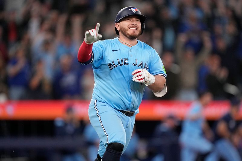 Apr 30, 2025; Toronto, Ontario, CAN; Toronto Blue Jays catcher Alejandro Kirk (30) reacts as he runs to first base on his RBI walk-off single against the Boston Red Sox during the tenth inning at Rogers Centre. Mandatory Credit: John E. Sokolowski-Imagn Images