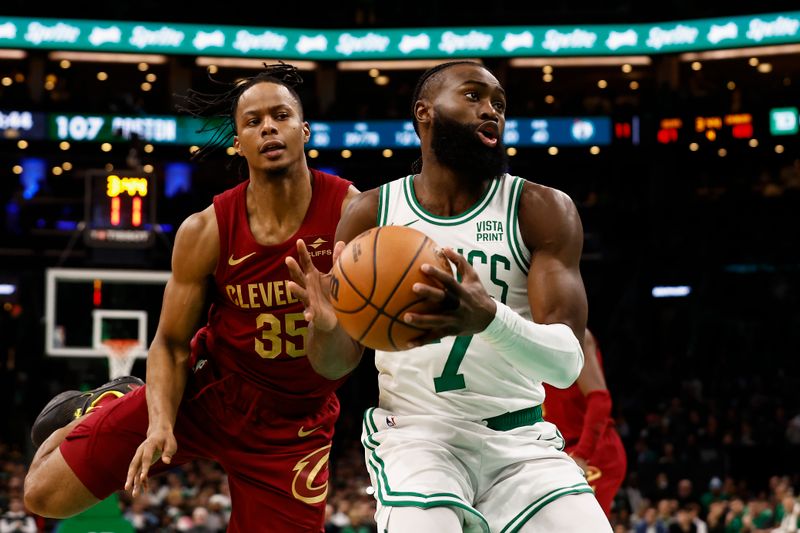 BOSTON, MA - DECEMBER 14: Jaylen Brown #7 of the Boston Celtics goes past Isaac Okoro #35 of the Cleveland Cavaliers during the second half at TD Garden on December 14, 2023 in Boston, Massachusetts. NOTE TO USER: User expressly acknowledges and agrees that, by downloading and/or using this Photograph, user is consenting to the terms and conditions of the Getty Images License Agreement. (Photo By Winslow Townson/Getty Images)