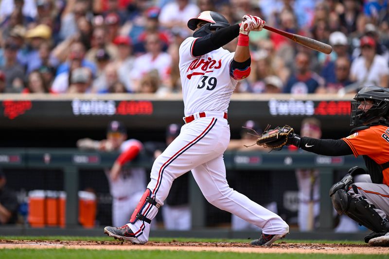 Jul 8, 2023; Minneapolis, Minnesota, USA;  Minnesota Twins infielder Donovan Solano (39) hits a double against the Baltimore Orioles during the first inning at Target Field. Mandatory Credit: Nick Wosika-USA TODAY Sports