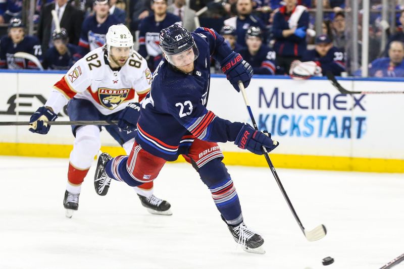 Mar 23, 2024; New York, New York, USA; New York Rangers defenseman Adam Fox (23) attempts a shot on goal in the second period against the Florida Panthers at Madison Square Garden. Mandatory Credit: Wendell Cruz-USA TODAY Sports