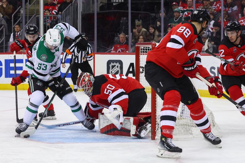 Jan 20, 2024; Newark, New Jersey, USA; New Jersey Devils goaltender Nico Daws (50) makes a save against the Dallas Stars during the first period at Prudential Center. Mandatory Credit: Ed Mulholland-USA TODAY Sports