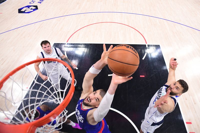 LOS ANGELES, CA - APRIL 21:  Ivica Zubac #40 of the LA Clippers grabs a rebound during the game against the Dallas Mavericks during Round 1 Game 1 of the 2024 NBA Playoffs on April 21, 2024 at Crypto.Com Arena in Los Angeles, California. NOTE TO USER: User expressly acknowledges and agrees that, by downloading and/or using this Photograph, user is consenting to the terms and conditions of the Getty Images License Agreement. Mandatory Copyright Notice: Copyright 2024 NBAE (Photo by Adam Pantozzi/NBAE via Getty Images)