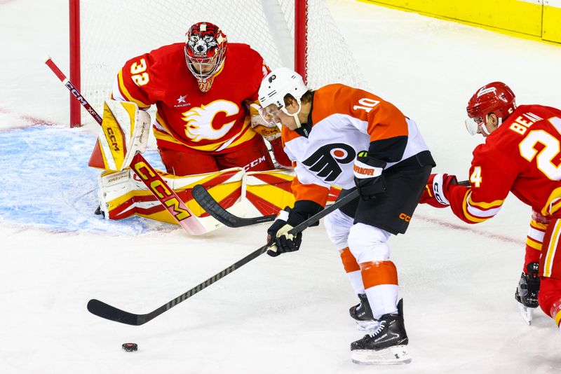 Oct 12, 2024; Calgary, Alberta, CAN; Calgary Flames goaltender Dustin Wolf (32) guards his net against Philadelphia Flyers right wing Bobby Brink (10) during the first period at Scotiabank Saddledome. Mandatory Credit: Sergei Belski-Imagn Images