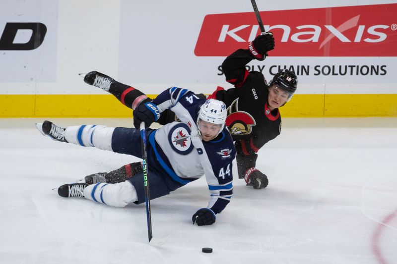 Jan 20, 2024; Ottawa, Ontario, CAN; Winnipeg Jets defenseman Josh Morrissey (44) and Ottawa Senators center Tim Stutzle (18) fall as they battle for the puck in the thirdcperiod at the Canadian Tire Centre. Mandatory Credit: Marc DesRosiers-USA TODAY Sports