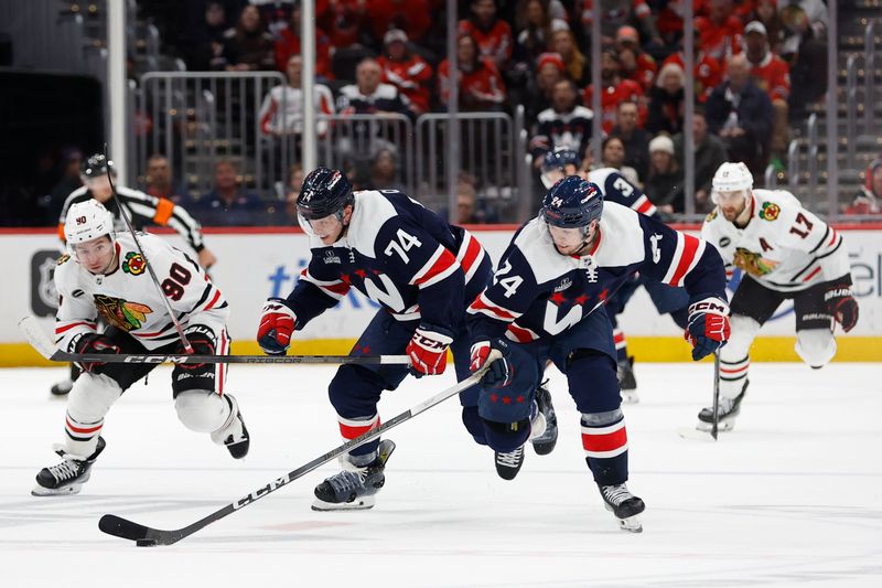 Mar 9, 2024; Washington, District of Columbia, USA; Washington Capitals center Connor McMichael (24) skates with the puck as Chicago Blackhawks center Tyler Johnson (90) defends at Capital One Arena. Mandatory Credit: Geoff Burke-USA TODAY Sports