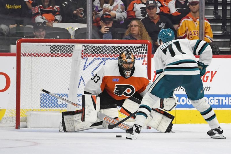 Nov 11, 2024; Philadelphia, Pennsylvania, USA; Philadelphia Flyers goaltender Samuel Ersson (33) makes a save against San Jose Sharks center Macklin Celebrini (71) during the shootout period at Wells Fargo Center. Mandatory Credit: Eric Hartline-Imagn Images