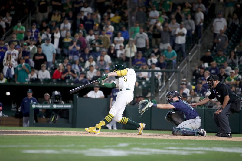 May 5, 2025; West Sacramento, California, USA; Athletics shortstop Jacob Wilson (5) hits a walk-off RBI single against the Seattle Mariners during the eleventh inning at Sutter Health Park. Mandatory Credit: Dennis Lee-Imagn Images