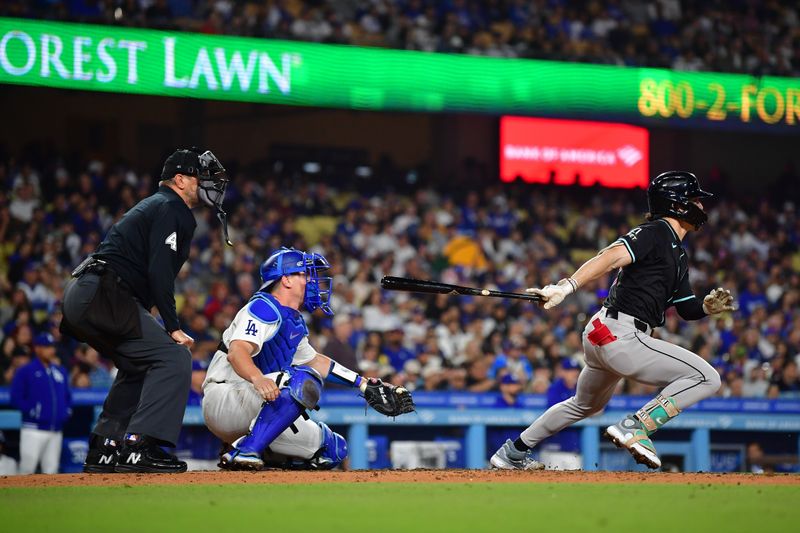 May 22, 2024; Los Angeles, California, USA; Arizona Diamondbacks center fielder Corbin Carroll (7) hits a two run RBI triple against the Los Angeles Dodgers during the fifth inning at Dodger Stadium. Mandatory Credit: Gary A. Vasquez-USA TODAY Sports