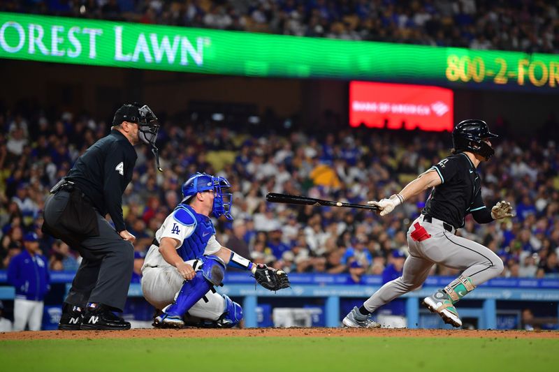 May 22, 2024; Los Angeles, California, USA; Arizona Diamondbacks center fielder Corbin Carroll (7) hits a two run RBI triple against the Los Angeles Dodgers during the fifth inning at Dodger Stadium. Mandatory Credit: Gary A. Vasquez-USA TODAY Sports