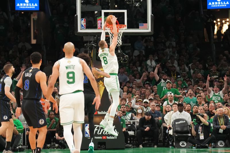 BOSTON, MA - JUNE 6: Kristaps Porzingis #8 of the Boston Celtics dunks the ball during the game against the Dallas Mavericks during Game 1 of the 2024 NBA Finals on June 6, 2024 at the TD Garden in Boston, Massachusetts. NOTE TO USER: User expressly acknowledges and agrees that, by downloading and or using this photograph, User is consenting to the terms and conditions of the Getty Images License Agreement. Mandatory Copyright Notice: Copyright 2024 NBAE  (Photo by Jesse D. Garrabrant/NBAE via Getty Images)