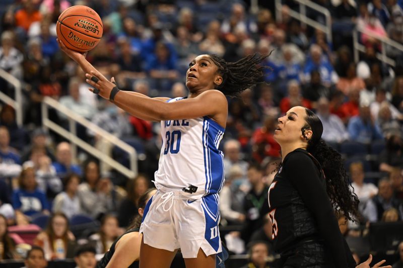 Mar 4, 2023; Greensboro, NC, USA; Duke Blue Devils guard Shayeann Day-Wilson (30) shoots the ball against Virginia Tech Hokies guard Kayana Traylor (23) during the second half at Greensboro Coliseum. Mandatory Credit: William Howard-USA TODAY Sports