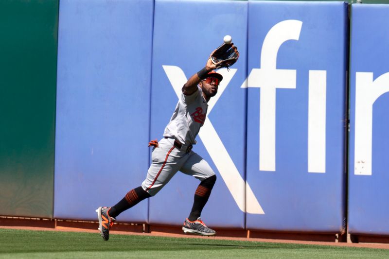Jul 7, 2024; Oakland, California, USA; Baltimore Orioles center fielder Cedric Mullins (31) makes a running catch of a fly ball by Oakland Athletics center fielder JJ Bleday during the ninth inning at Oakland-Alameda County Coliseum. Mandatory Credit: D. Ross Cameron-USA TODAY Sports