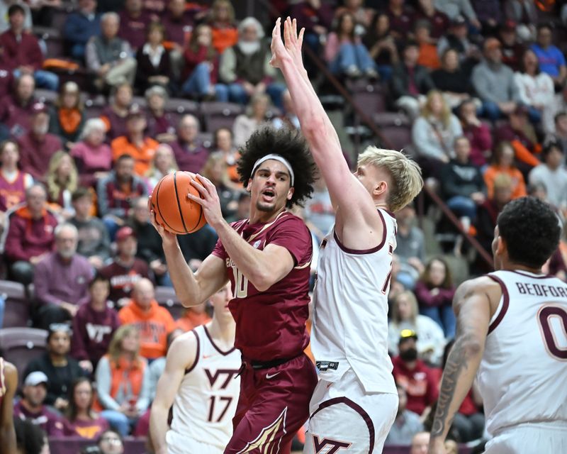 Feb 14, 2026; Blacksburg, Virginia, USA;  Florida State Seminoles guard Lajae Jones (10) looks to pass the ball as Virginia Tech Hokies center Antonio Dorn (77) defends during the first half at Cassell Coliseum. Mandatory Credit: Brian Bishop-Imagn Images