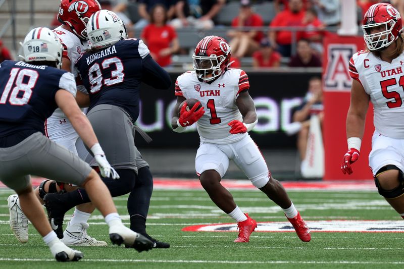 Nov 18, 2023; Tucson, Arizona, USA; Utah Utes running back Jaylon Glover (1) runs the ball against Arizona Wildcats defensive lineman Jacob Kongaika (93) during the first half at Arizona Stadium. Mandatory Credit: Zachary BonDurant-USA TODAY Sports