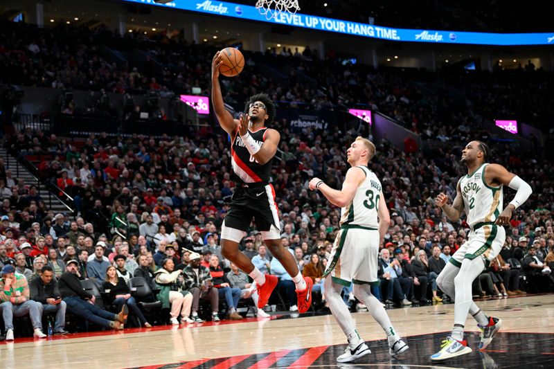 PORTLAND, OREGON - MARCH 11: Scoot Henderson #00 of the Portland Trail Blazers goes up for a layup in the third quarter against the Boston Celtics at the Moda Center on March 11, 2024 in Portland, Oregon. The Boston Celtics won 121-99. NOTE TO USER: User expressly acknowledges and agrees that, by downloading and or using this photograph, User is consenting to the terms and conditions of the Getty Images License Agreement. (Photo by Alika Jenner/Getty Images)