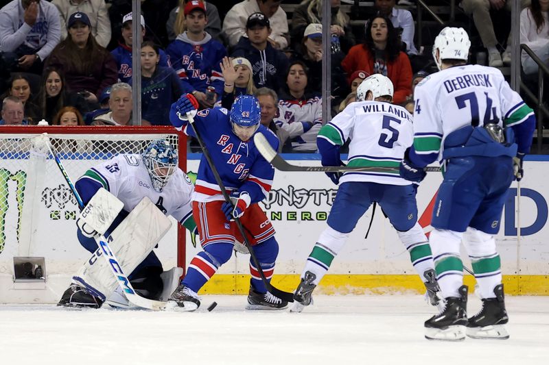 Dec 16, 2025; New York, New York, USA; New York Rangers left wing Conor Sheary (43) plays the puck against Vancouver Canucks goaltender Thatcher Demko (35) and defenseman Tom Willander (5) during the third period at Madison Square Garden. Mandatory Credit: Brad Penner-Imagn Images