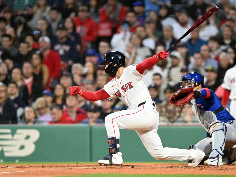 Apr 28, 2024; Boston, Massachusetts, USA; Boston Red Sox catcher Connor Wong (12) hits a RBI against the Chicago Cubs during the first inning at Fenway Park. Mandatory Credit: Brian Fluharty-USA TODAY Sports