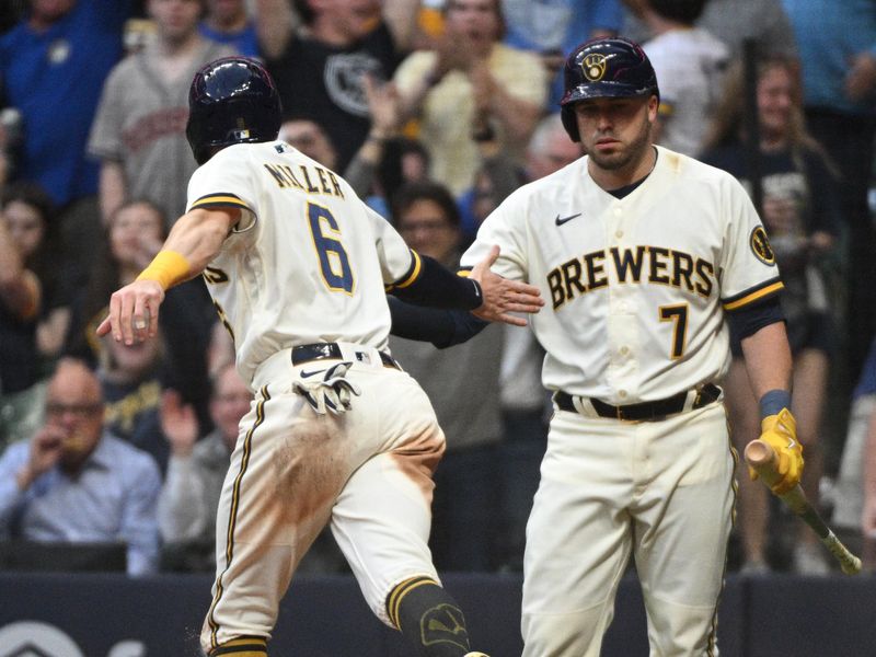 May 23, 2023; Milwaukee, Wisconsin, USA; Milwaukee Brewers second baseman Owen Miller (6) slides in safely and is congratulated by catcher Victor Caratini (7) against the Houston Astros in the fourth inning at American Family Field. Mandatory Credit: Michael McLoone-USA TODAY Sportsat American Family Field. Mandatory Credit: Michael McLoone-USA TODAY Sports